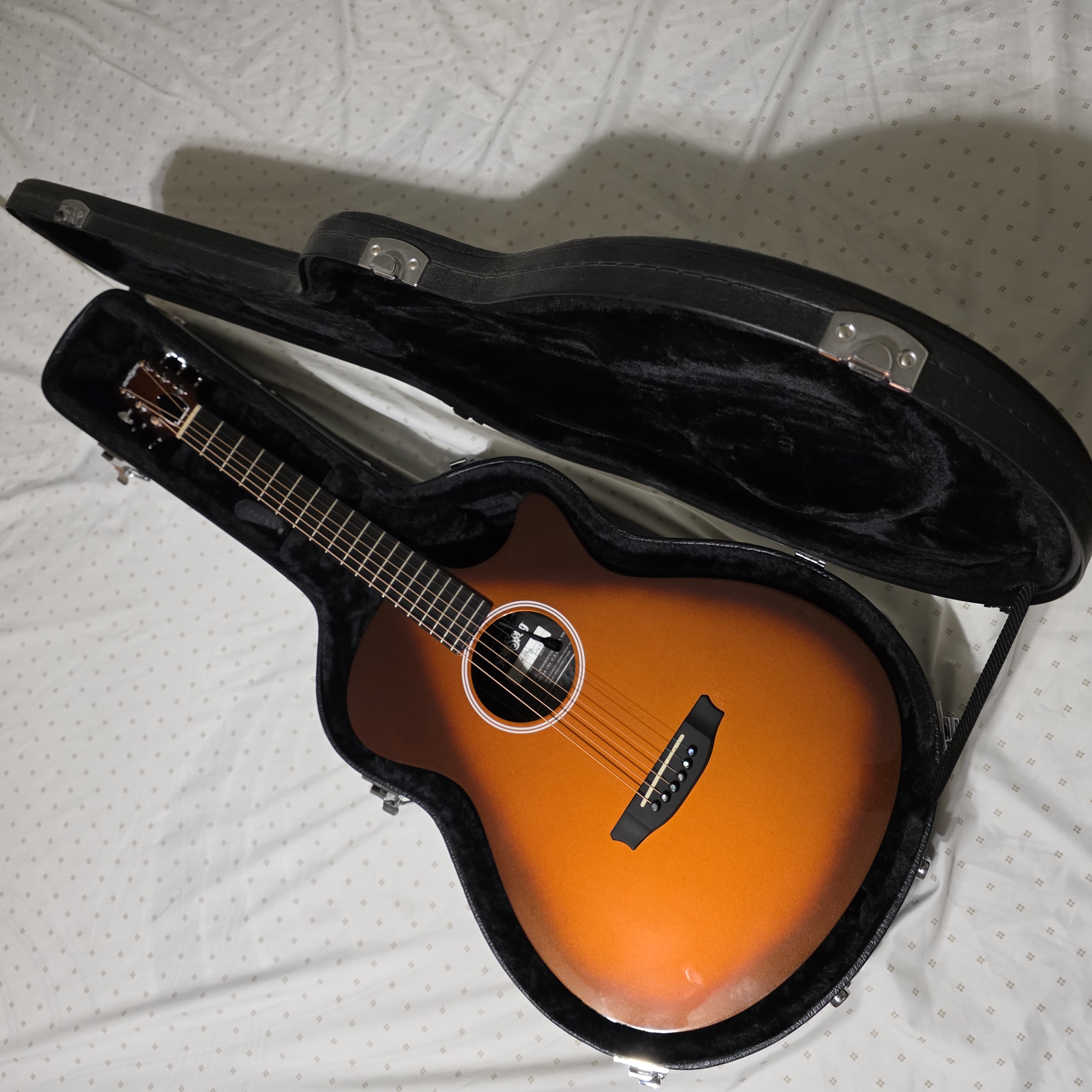 Sunburst acoustic guitar in an open case