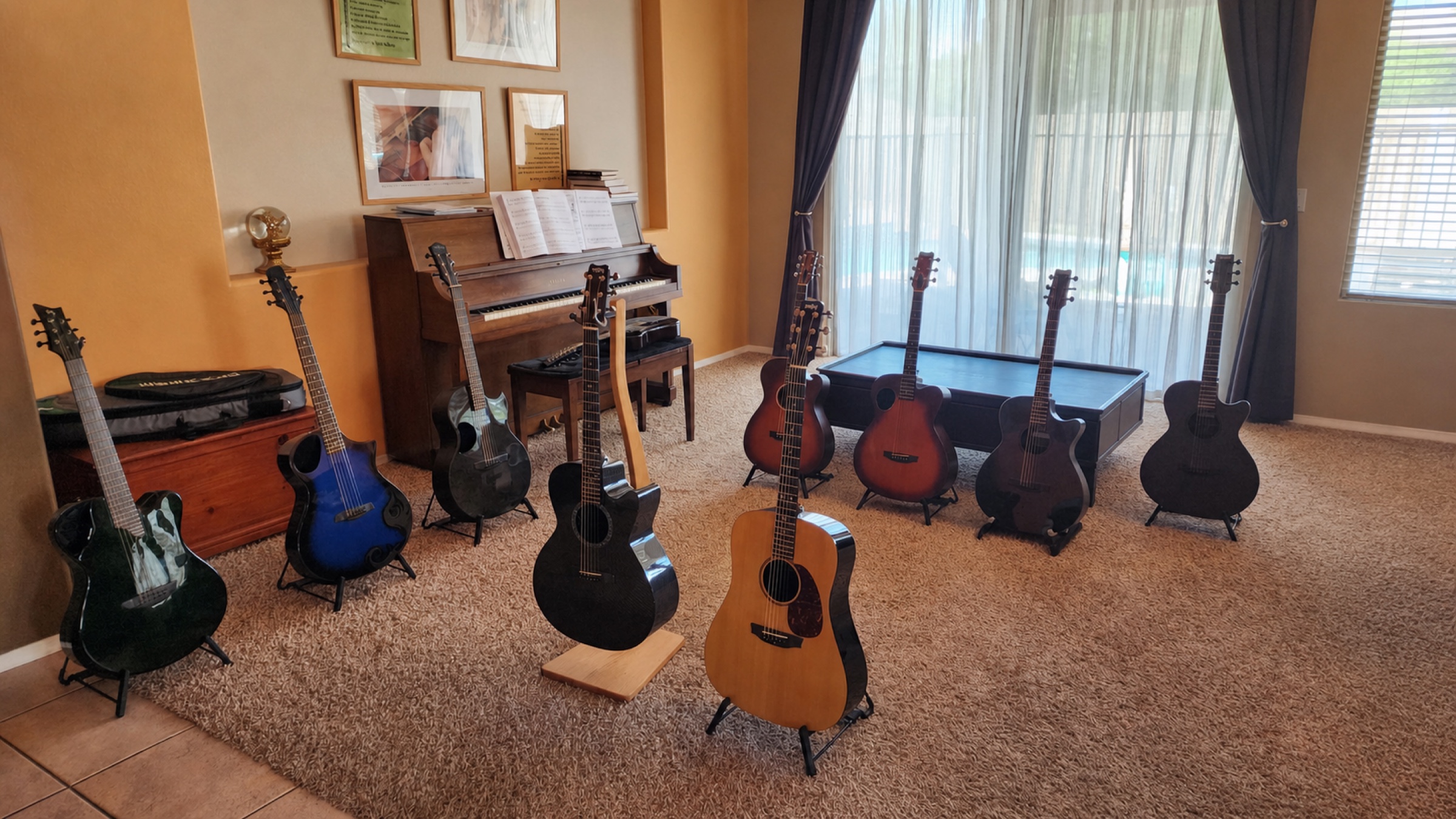 Acoustic guitars set up in Andrew's living room for potential buyers